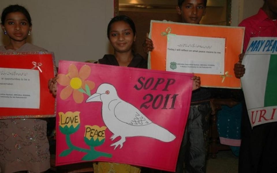 young girls holding posters 