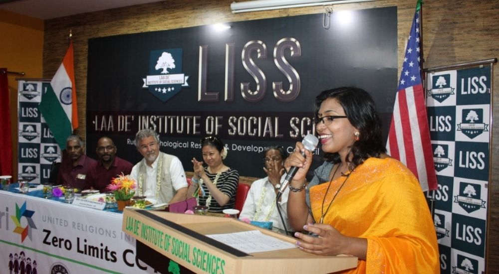 Dr. Devi Raj, Co-Founder of URI Zero Limits, speaks in front of a panel that includes The Rev. Victor H. Kazanjian, Jr., URI Executive Director, and Isabelle Ortega-Lockwood, URI Director of Global Communications and Strategic Planning