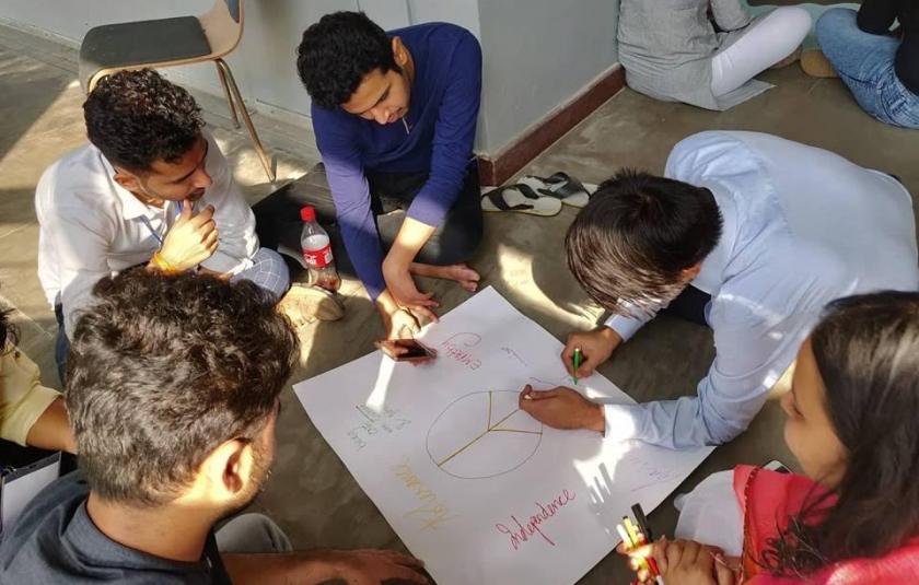 Photo: A group of students working on a chart paper