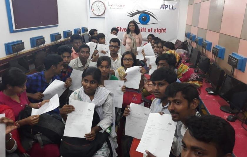 Students sitting in a room and writing on paper.