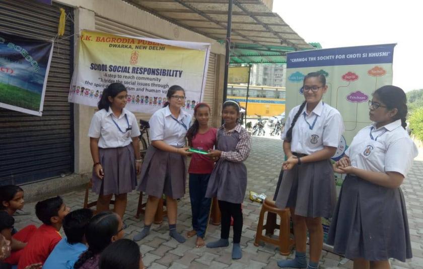 A group of schoolgirls posing with another girl.