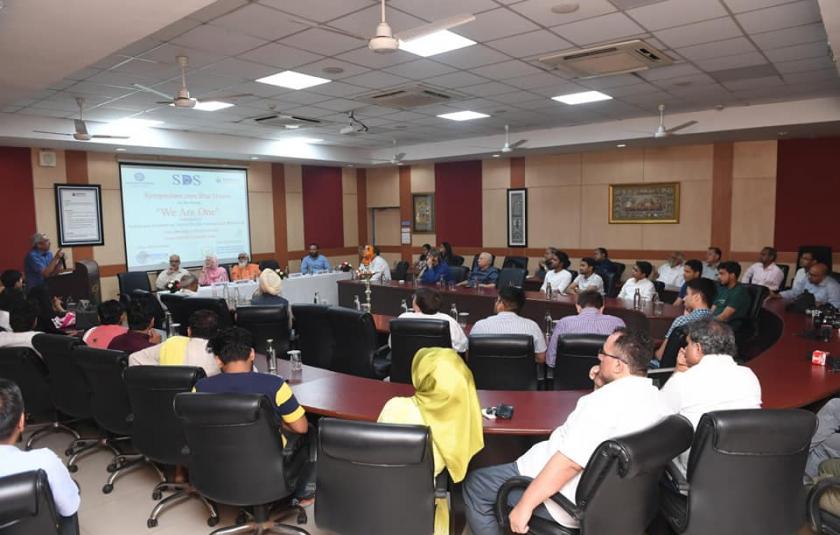 A group of people sitting in a conference room.