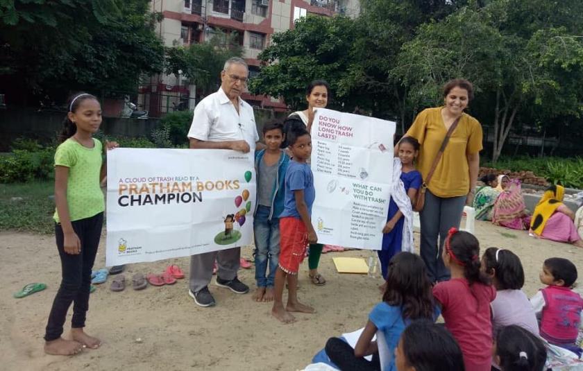 A group of children posing with banners in their hands.