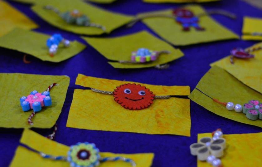 A photo of handmade Rakhis kept on a table.