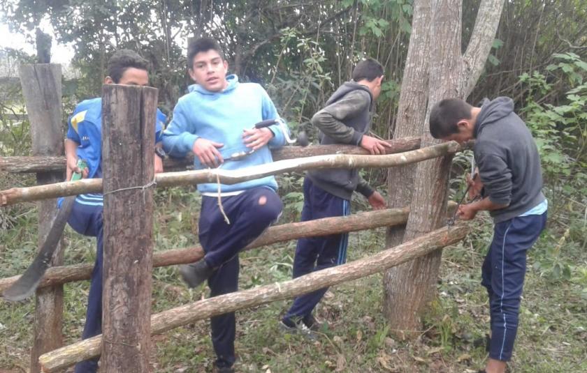 Slideshow: Young boys building a fence. 