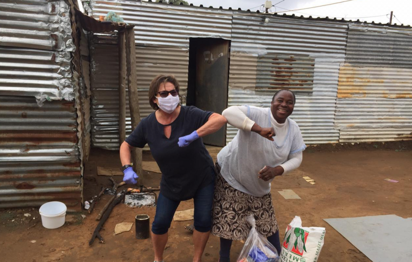 Photo: two people distributing food hampers