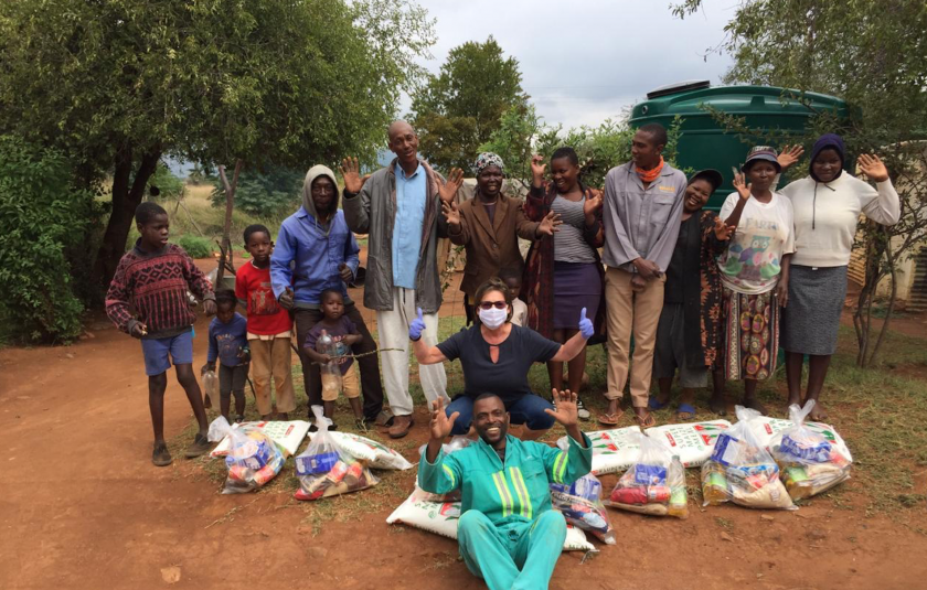 Photo: group gathers with food hampers
