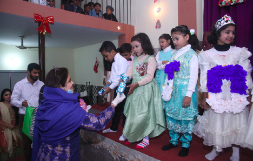 Photo: Women handing Christmas gifts to children