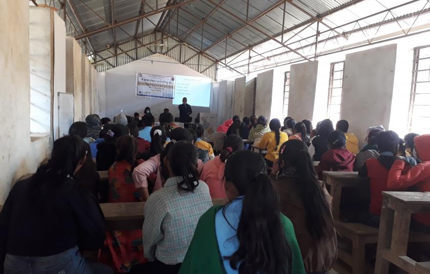 Photo: Children listening to the facilitators in a classroom