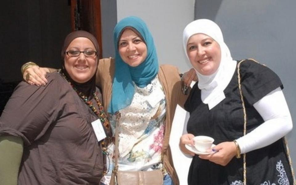 three women taking a group photo