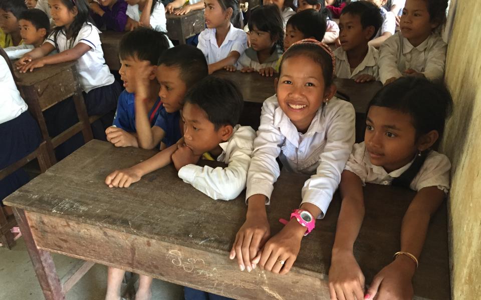 Schoolchildren at a wooden desk