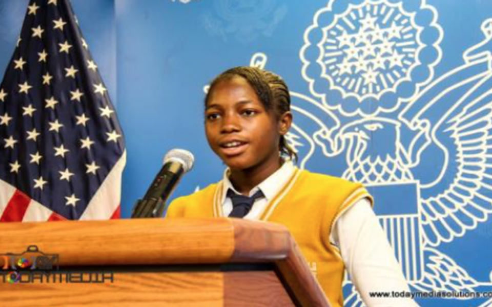 young women speaking at the podium 