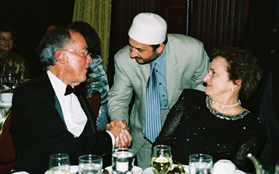 Bill shaking hands with a Muslim representative 