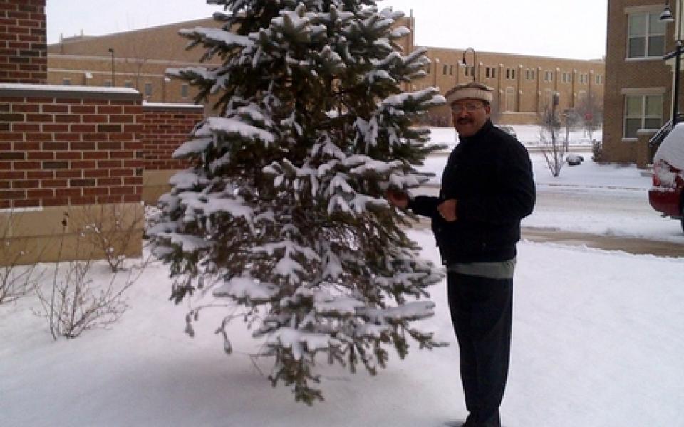 father james sitting on a snow 