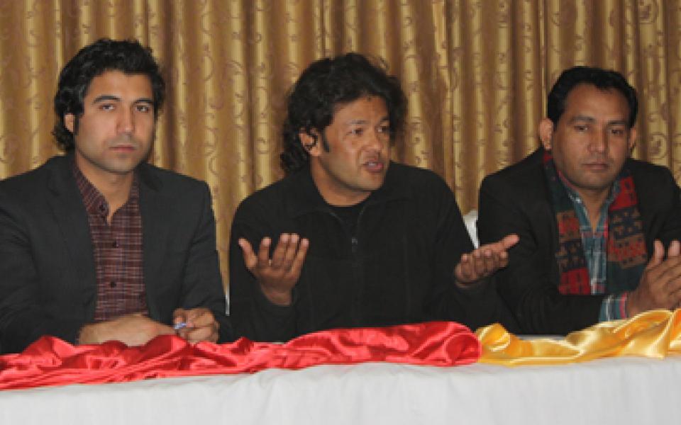 irfan speaking to an audience, while sitting in a panel  