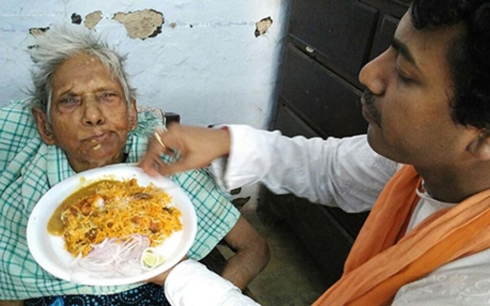 A man feeding his mom