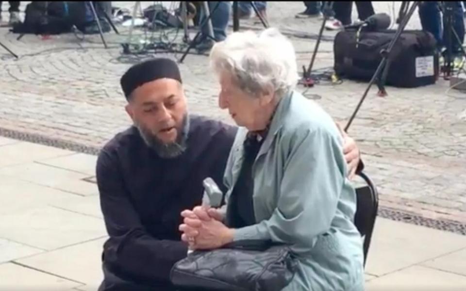A man comforting an old woman