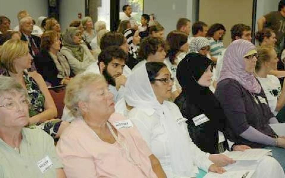 audience are listening to a speaker  