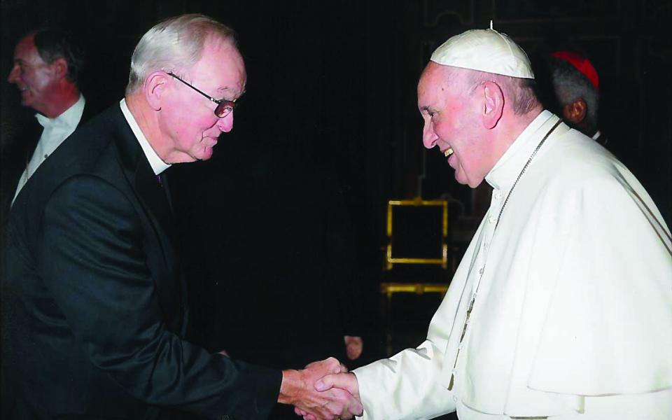 Pope Francis and Bishop Swing shake hands.