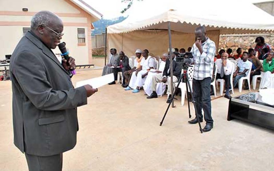 UgandaURI15-Trustee Bishop Odama reads Golden Rule.jpg