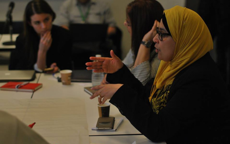 A Muslim woman speaking in discussion 