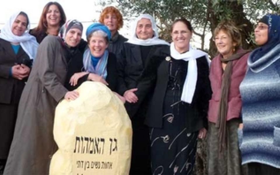 women holding on a rock in northern Palestine