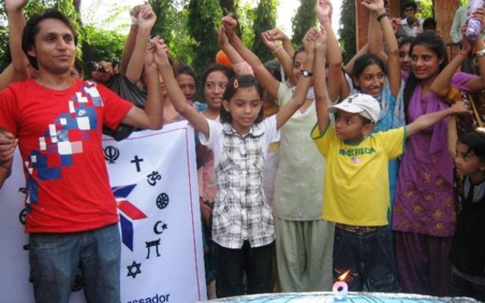 youth are holding their hands up together 