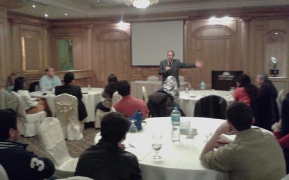 A man is speaking to young students