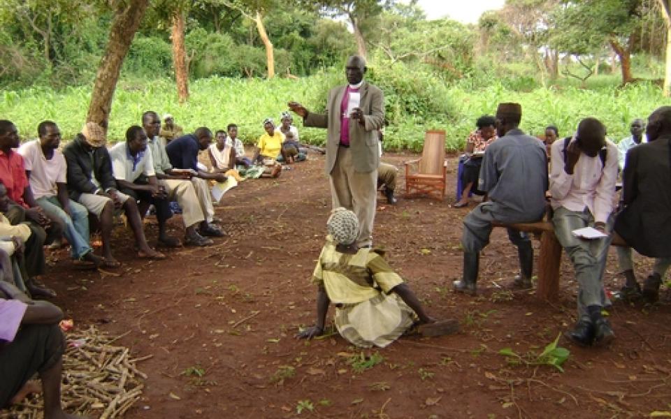 A man is mediating a dispute while standing and speaking 