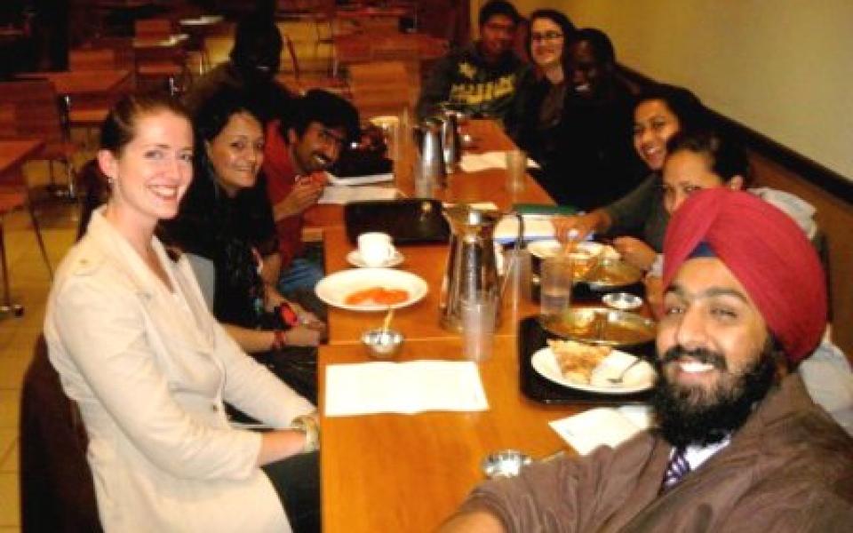 a group of youth individuals seating at a restaurant 