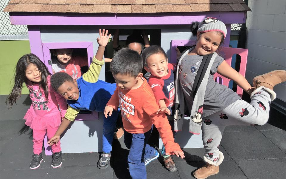 GLIDE ministries participants playing in their new Habitat playhouse