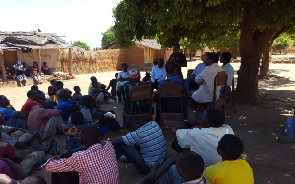 Photo of a man talking to a group