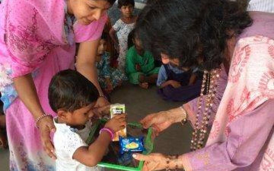 Satya plays with school children.