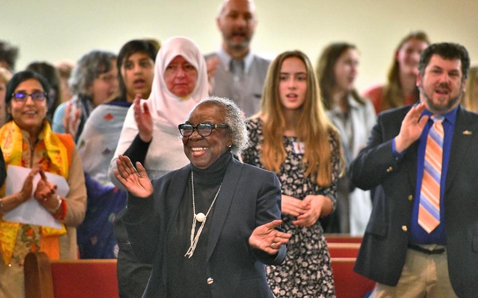 Image Description: Dr. Joan Hillsman leads the audience in the opening song. The 9th Annual World Interfaith Assembly at Southern Missionary Baptist Church, 3143 Midland Ave., Syracuse, photo courtesy of Michael Greenlar | mgreenlar@syracuse.com