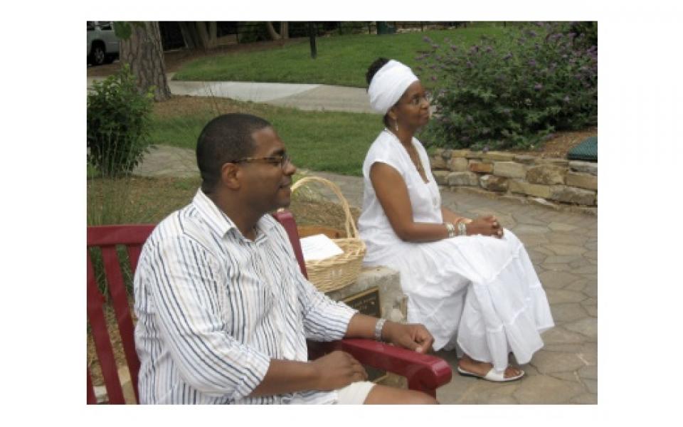 Photo: Image of Adeola Fearon seated on one of the Charlotte Red Bench Project benches.