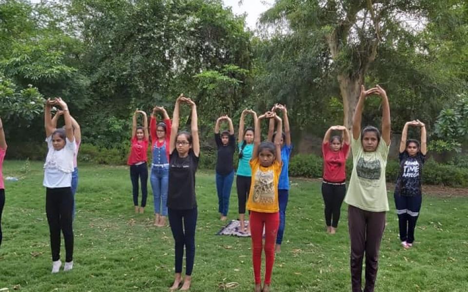 A bunch of kids doing yoga.