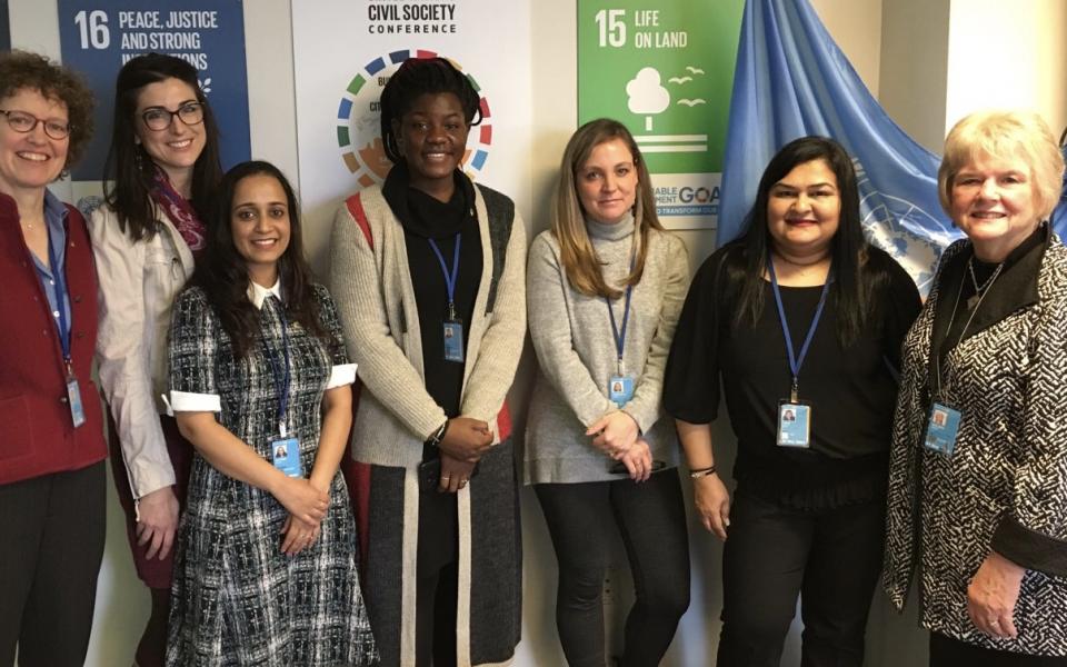 Sanniyah (middle) participates in a meeting at the United Nations. 