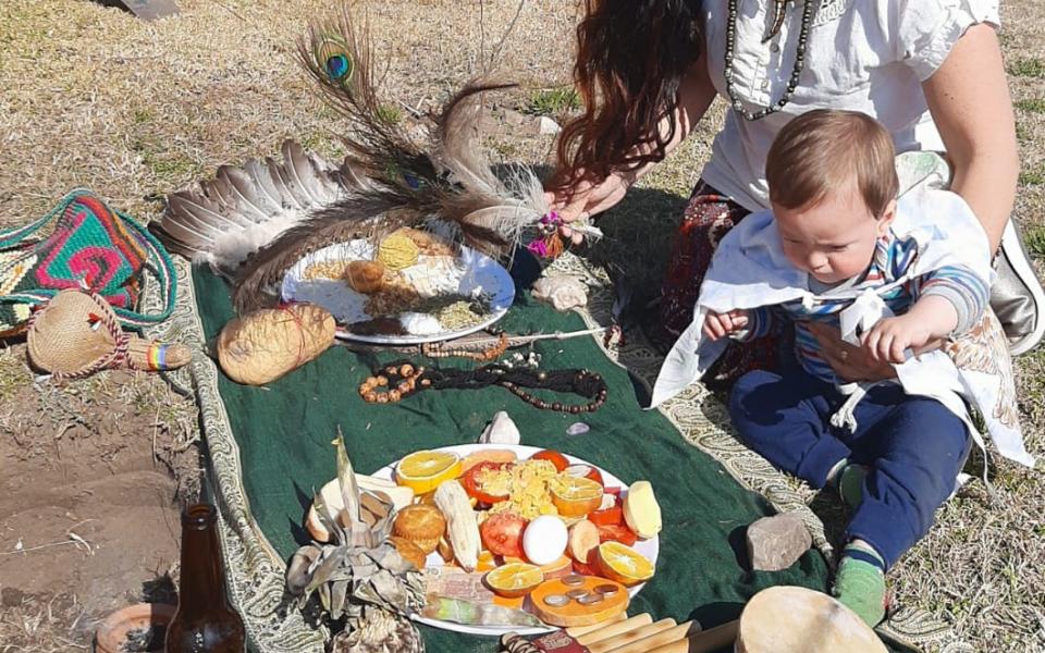 Photo: The second member CC and her child making the offering.
