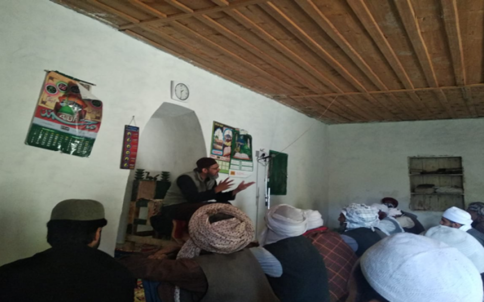 Photo: A man talking to a group of people