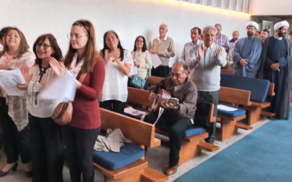 Photo: Diferente members of various religions united in a Christian church.