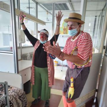 Photo: Members of the Sonrio CC dressed like clowns entertaining the children 